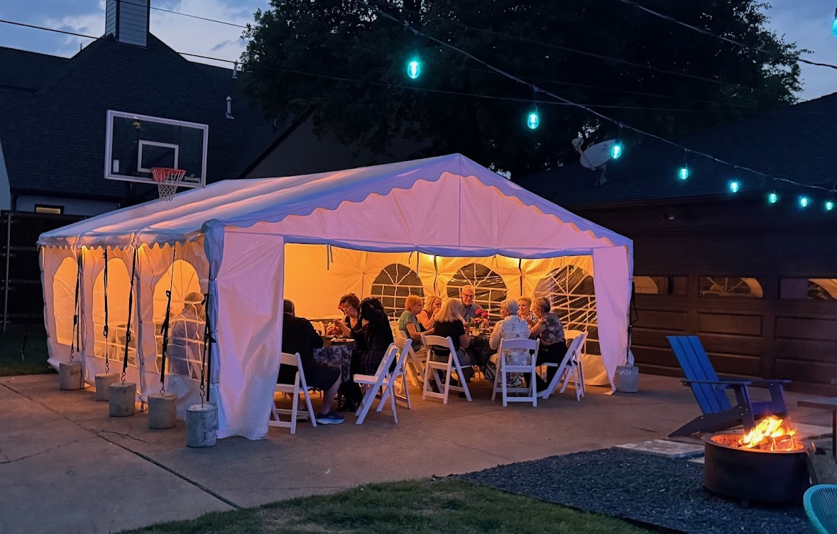 Frame tent set up on hard surface with evening lighting