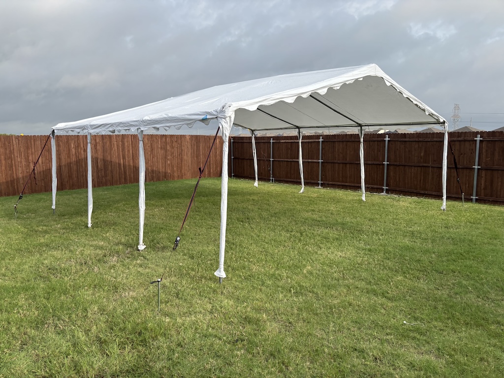 Frame tent with walls rolled up for open airflow